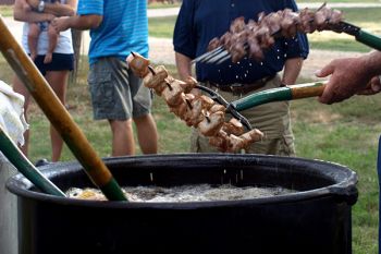 An old scalding pot, homemade burner and 25 gallons of peanut oil are used to cook the pork and beef chunks.