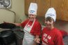 Sheryl Steinocker and Diane Knutson carefully watch over the boiling pots of lutefisk.