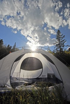 Backlighting clouds with the sun gives them a nice glow as it does for the tent here as well.