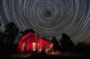 Ploog used a 7.5 hour exposure, his longest thus far, for this photo of an old Black HIlls cabin. An 8 second break was needed to change the camera battery. Red lighting was applied by hand to the exterior and yellow lighting to the interior.