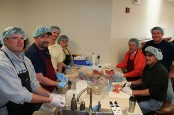 Dakota Provisions employees turn turkey testicles into Fowl Balls. From left: Brad Peterson, James Shultz, Brian Goertz, Tonya Adermann, Jim Hein, John Hott, Rick Shulz.