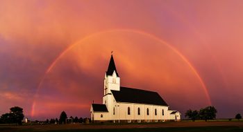 Full rainbow over Immanuel Lutheran around sunset.