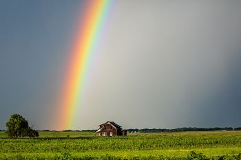 Rainbow over an abandoned farmhouse.