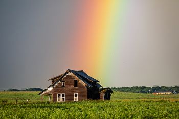 Rainbow over an abandoned farmhouse.