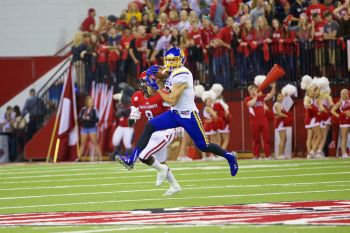 SDSU standout wide receiver Jake Wieneke catches a ball over the USD logo at midfield in the 2015 game.