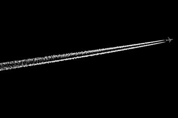 A jet with contrails above Good Earth State Park in black and white.