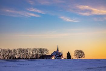 First sunlight of the third Sunday of Advent striking the windows of Skrefsrud Lutheran of rural Lincoln County.