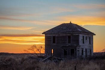 Sunset beyond an abandoned house in rural Buffalo County.