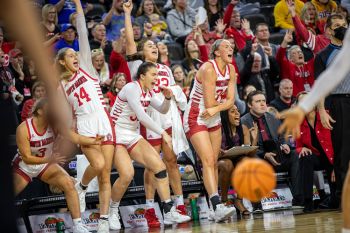 USD’s women’s bench and fans behind them erupt in celebration.