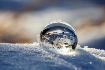 Lens ball in the snow and sunshine.