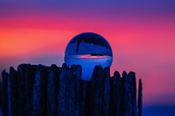 Lens ball on an old corner post under a South Dakota sunset.