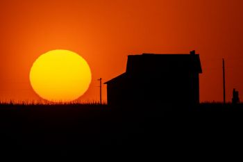 Sunset beyond an old country schoolhouse in the Fort Pierre National Grasslands.