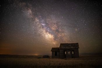 The milky way rising above an old country school in rural Stanley County.