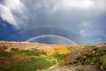 Double rainbow over the yellow mound area of Badlands National Park.