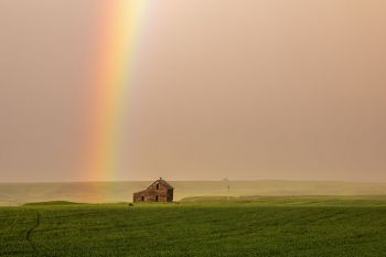 Abandoned house with rainbow.