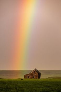 Abandoned house with rainbow.