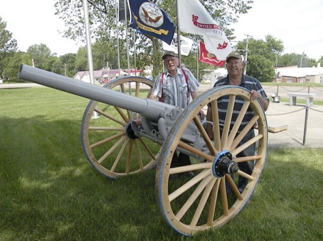 Jim Tapken and Walter Borkowski, members of Willman-Fee Post #14 of the American Legion, stand next to the newly-restored cannon. Photo by Duke Wenzel, True Dakotan.