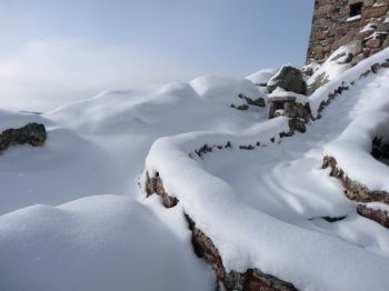 Fresh snow blankets the steps to the old granite fire tower, used to spot blazes until 1967.