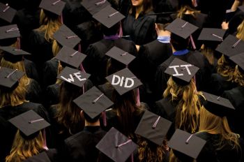 Graduates coordinated an enthusiastic message at a South Dakota State University ceremony. Photo by Greg Latza.