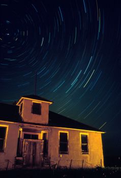 A one-hour time exposure shows stars ringing the North Star above an old schoolhouse in Capa.