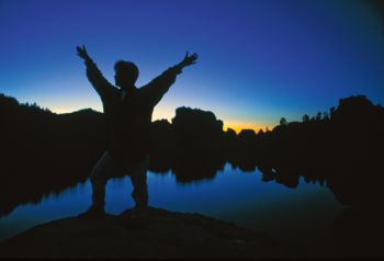 Jodi Latza enjoys the darkness atop boulders at Sylvan Lake. Photos by Greg Latza.