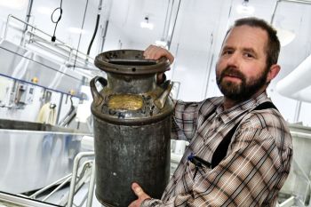 Jeremy Wipf says Spink Colony has a long dairy history, as evidenced by an antique milk can that is on exhibit at the new cheese factory.