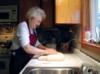 Timber Lake’s Mary Biegler was photographed making caramel rolls for the cover of the 2010 Holiday Cookbook.