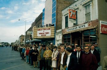 This 1967 photo shows University of South Dakota Students watching for the Dakota Days Parade in front of the old Co-Ed Theater (now Coyote Twin).